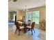 Beautiful dining space with a glass table, wicker chairs, and a large window at 3721 Adelaide Ave, North Port, FL 34288