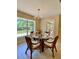 Bright dining area with a glass-top table and wicker chairs, perfect for Gathering meals at 3721 Adelaide Ave, North Port, FL 34288