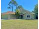 Well-maintained single-story home showcasing its lush lawn, mature trees, and charming curb appeal at 3721 Adelaide Ave, North Port, FL 34288