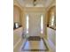 Inviting foyer with decorative tile accents and a beautiful mirror to welcome guests at 3721 Adelaide Ave, North Port, FL 34288