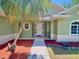 Charming single-story home with a decorative oval window and vibrant front yard landscaping at 3721 Adelaide Ave, North Port, FL 34288