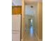 View of the hall leading to other rooms with a partial view of a kitchen to the left at 3721 Adelaide Ave, North Port, FL 34288