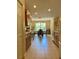 Well-lit kitchen with wooden cabinetry, and view to dining area at 3721 Adelaide Ave, North Port, FL 34288