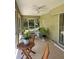Inviting screened lanai with cozy seating and view to the backyard at 3721 Adelaide Ave, North Port, FL 34288