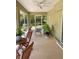Relaxing screened lanai with cozy seating and a lush garden view at 3721 Adelaide Ave, North Port, FL 34288