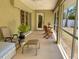 Screened lanai with comfortable seating and view of the backyard at 3721 Adelaide Ave, North Port, FL 34288