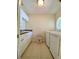 Bright laundry room with modern washer and dryer and ample cabinet space at 3721 Adelaide Ave, North Port, FL 34288