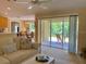Comfortable living room with patio view and open access to dining area at 3721 Adelaide Ave, North Port, FL 34288