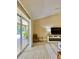 Bright living area featuring a sliding glass door to the patio with a TV and decor at 3721 Adelaide Ave, North Port, FL 34288