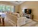 Cozy living room with a view of the patio, furnished with stylish decor at 3721 Adelaide Ave, North Port, FL 34288