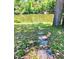 Stepping stone path leading to a picturesque waterfront with mature trees at 3721 Adelaide Ave, North Port, FL 34288