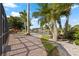 Paver path to canal with lush tropical landscaping, mature palms, and beautiful water views at 441 Norma Ct, Punta Gorda, FL 33950