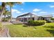 Well-manicured lawn and landscaped backyard with a screened lanai, offering a private outdoor space at 441 Norma Ct, Punta Gorda, FL 33950