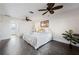 Light-filled bedroom with two ceiling fans, gray tile floor, and a comfortable queen-sized bed at 441 Norma Ct, Punta Gorda, FL 33950