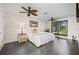 Serene bedroom with dark floors, a large window with louvers, and two ceiling fans at 441 Norma Ct, Punta Gorda, FL 33950