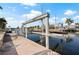 Canal dock featuring a boat lift, offering convenience for boat owners and water enthusiasts at 441 Norma Ct, Punta Gorda, FL 33950
