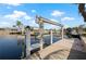 Dock with boat lift offers easy access to the canal for boating and water activities at 441 Norma Ct, Punta Gorda, FL 33950