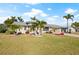 Lovely home featuring mature palm trees, well-manicured lawn, and a neutral color palette at 441 Norma Ct, Punta Gorda, FL 33950