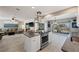 Open concept kitchen with a modern island, stainless steel appliances, and seamless flow to the living area at 441 Norma Ct, Punta Gorda, FL 33950