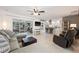 Spacious living room with tile flooring, a ceiling fan, and access to the outdoors through sliding glass doors at 441 Norma Ct, Punta Gorda, FL 33950