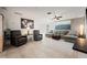 Inviting living room with tile floors, comfortable seating, and a large wall art piece at 441 Norma Ct, Punta Gorda, FL 33950
