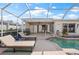 Welcoming pool with lounge chairs, a grill, and a convenient outdoor living area for relaxation and entertaining at 441 Norma Ct, Punta Gorda, FL 33950