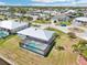 Aerial view of the house featuring a screened pool, lawns, and canal at 5194 Cooper Ter, Port Charlotte, FL 33981