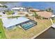 An aerial view of a waterfront property with canal access and a pool at 5194 Cooper Ter, Port Charlotte, FL 33981