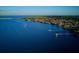 Stunning aerial view of the waterways, with boat docks, and a lush treeline in the distance at 5194 Cooper Ter, Port Charlotte, FL 33981
