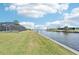 A waterfront property with lawn and screened pool at 5194 Cooper Ter, Port Charlotte, FL 33981
