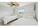 Comfortable bedroom with two twin beds, neutral decor, fan, and plenty of natural light at 5194 Cooper Ter, Port Charlotte, FL 33981
