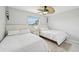 Comfortable bedroom with two twin beds, neutral decor, fan, and plenty of natural light at 5194 Cooper Ter, Port Charlotte, FL 33981