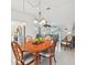 Bright dining area adjacent to the living room boasts a wood table, tiled floor, and coastal decor at 5194 Cooper Ter, Port Charlotte, FL 33981