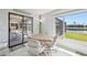 Charming dining area with a table and views of the screened-in patio and waterway at 5194 Cooper Ter, Port Charlotte, FL 33981