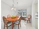 Charming dining area featuring a wooden table, comfortable chairs, and scenic views of the lanai at 5194 Cooper Ter, Port Charlotte, FL 33981