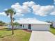 Inviting single-story home featuring a metal roof, well-maintained landscaping, and an attached two-car garage at 5194 Cooper Ter, Port Charlotte, FL 33981