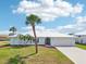 Beautiful single-story home with lush landscaping, featuring a well-manicured lawn and an attached garage at 5194 Cooper Ter, Port Charlotte, FL 33981