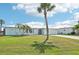 Beautiful single-Gathering home with palm trees, a metal roof, and a well-maintained lawn at 5194 Cooper Ter, Port Charlotte, FL 33981