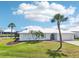Lovely home with a well-kept lawn, beautiful palm trees, and a durable metal roof at 5194 Cooper Ter, Port Charlotte, FL 33981