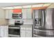 Kitchen features stainless appliances, tile backsplash, and modern design elements at 5194 Cooper Ter, Port Charlotte, FL 33981
