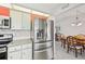 Kitchen with granite countertops, stainless appliances and view to the dining and living areas at 5194 Cooper Ter, Port Charlotte, FL 33981