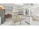 Open kitchen featuring granite countertops, island with sink, stainless appliances and tiled floor at 5194 Cooper Ter, Port Charlotte, FL 33981