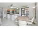 Open kitchen with granite countertops, stainless steel appliances, and a breakfast bar, flowing into dining area at 5194 Cooper Ter, Port Charlotte, FL 33981