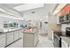 Spacious kitchen with granite island and stainless appliances that flows into the living area at 5194 Cooper Ter, Port Charlotte, FL 33981