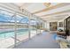 Spacious screened lanai with ceiling fan offers views of the pool and the canal beyond at 5194 Cooper Ter, Port Charlotte, FL 33981