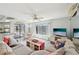 Comfortable living room featuring a modern sectional sofa and views of the outdoor pool and waterway at 5194 Cooper Ter, Port Charlotte, FL 33981