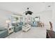 Bright living room with light walls, tile floors, large windows, and comfortable blue couches at 5194 Cooper Ter, Port Charlotte, FL 33981