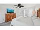 Cozy bedroom features stylish furniture, soft lighting, and a mounted television for relaxation at 5194 Cooper Ter, Port Charlotte, FL 33981