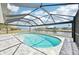 Inviting pool with screened enclosure offers a refreshing escape with a view of the canal at 5194 Cooper Ter, Port Charlotte, FL 33981