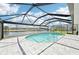 Sparkling pool with screened enclosure offers a relaxing retreat with scenic waterfront views at 5194 Cooper Ter, Port Charlotte, FL 33981